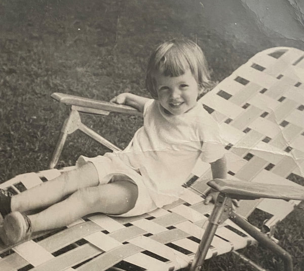 Me at 2 on a chaise lounge in the backyard. 
